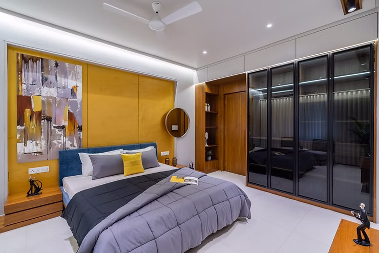 Master bedroom with feature wall and wardrobe design in Madurai home