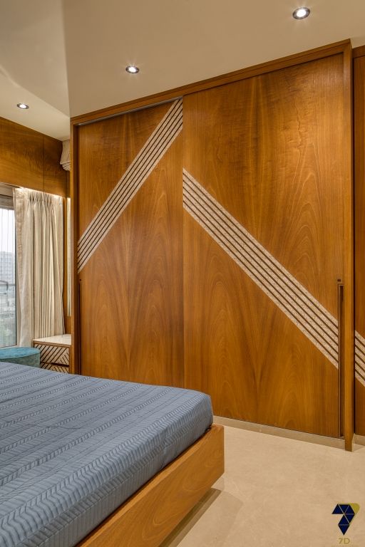 Bedroom wardrobe placement along longest wall in Madurai home Furnhomes